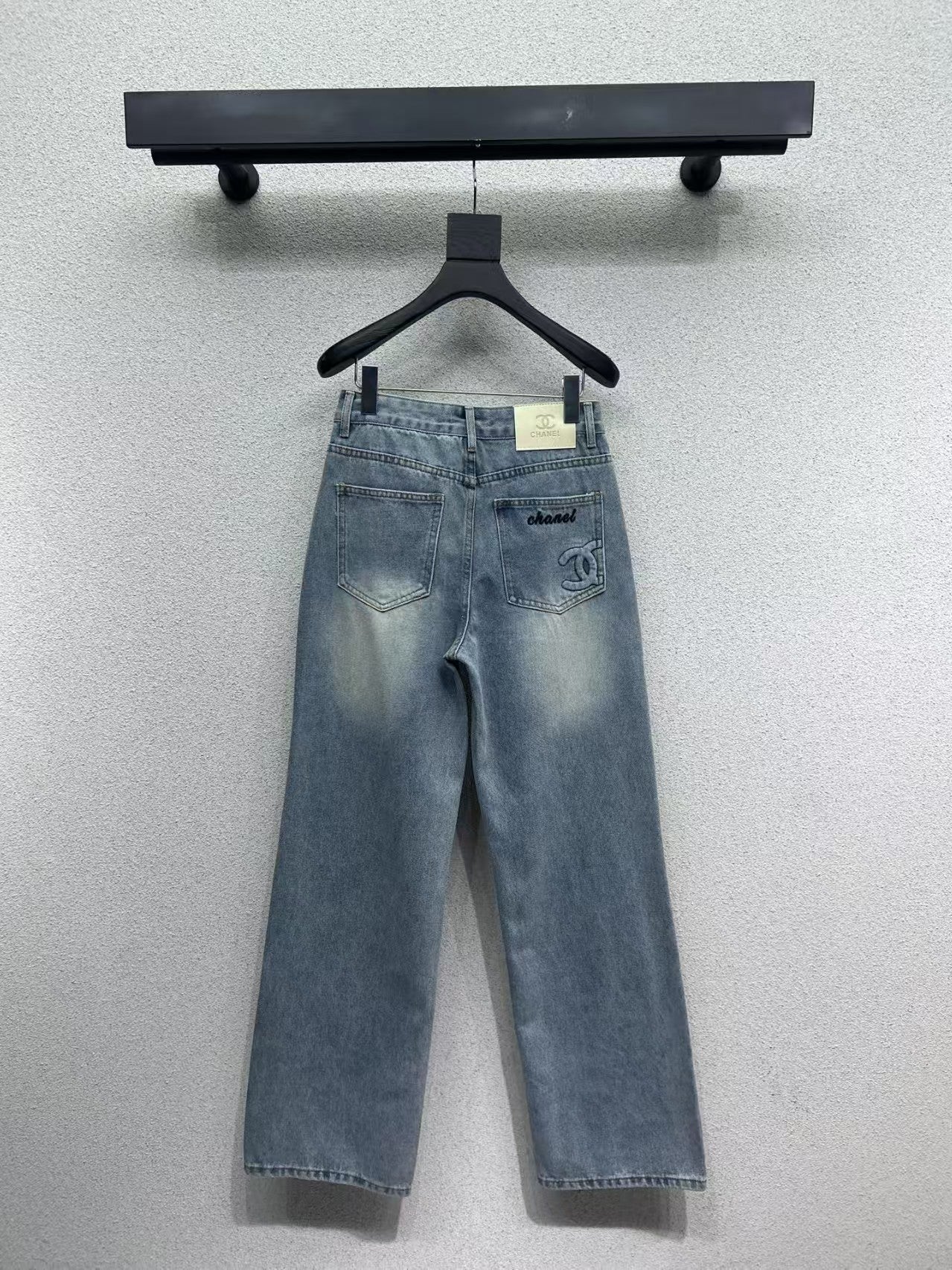 Denim trousers with embossed logo on pocket