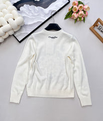 Wool sweater with gold floral and star embroidery