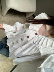 Single-breasted pleated long-sleeved shirt with a baby doll collar