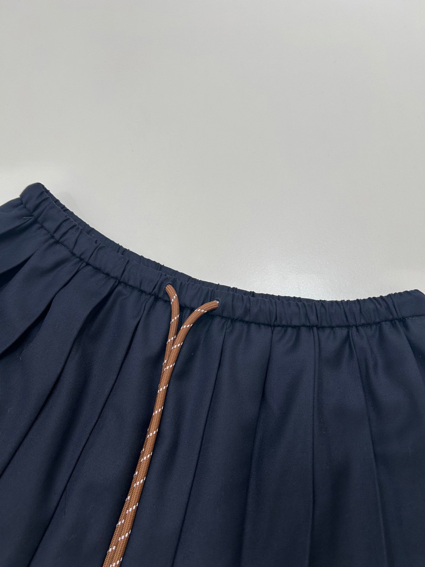 Mini-jupe plissée bleu marine avec cordon de serrage à la taille