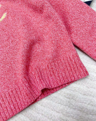 Pink jacquard knit long sleeves with dropped shoulders and button detail