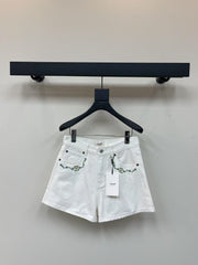 White denim shorts with embroidered letters